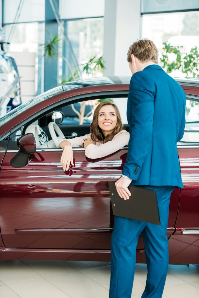 Manager talking with a customer after test-driving a car