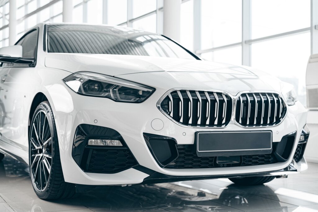 White luxury passenger car standing inside salon