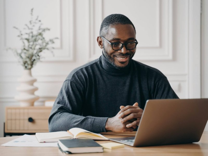 African American male private consultant having session online listens to client attentively