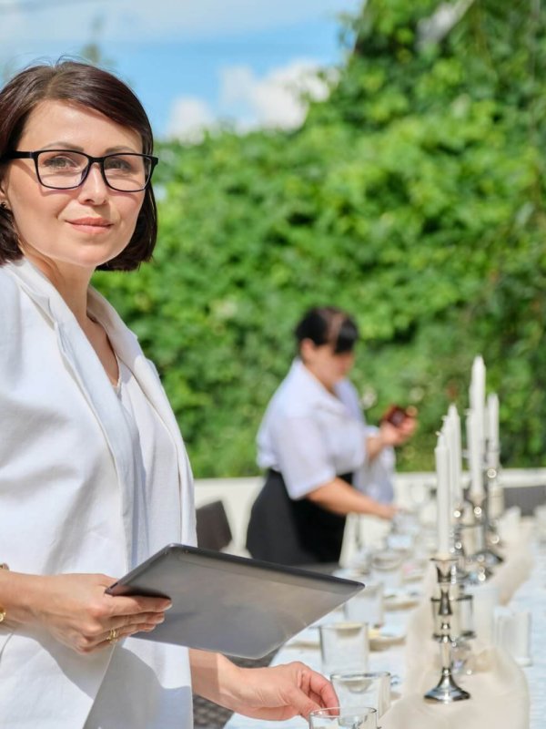 Organization of weddings, parties, catering for events. Female on the background banquet decorated