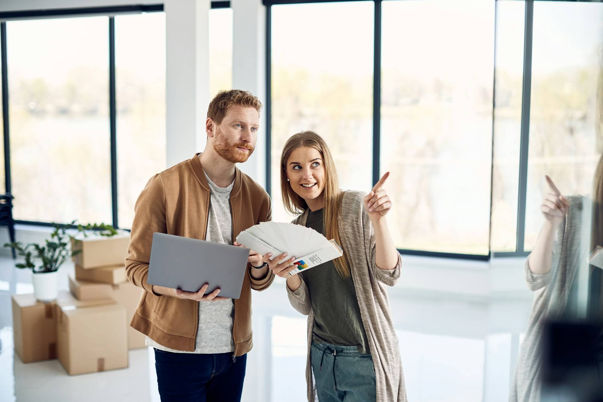 Young couple talking while making decisions for their home renovations.