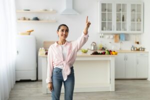 Smart Home Concept. Millennial Woman Pointing Finger Up In Air