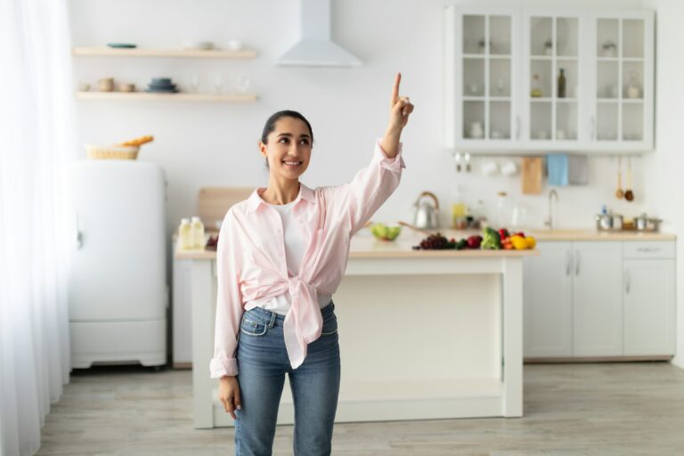 Smart Home Concept. Millennial Woman Pointing Finger Up In Air