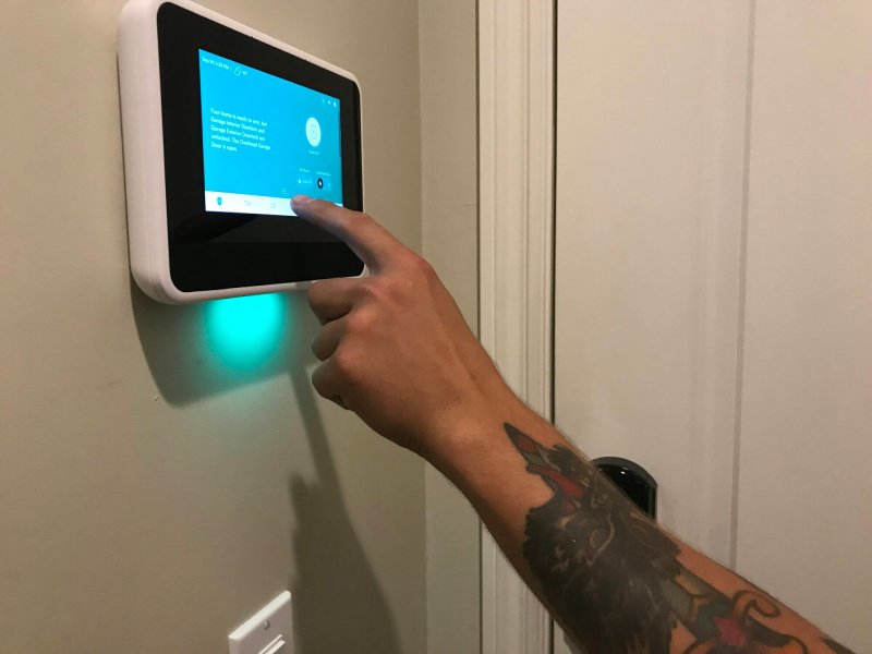 A Technician gives instructions on Programming the home security panel in a smart home.