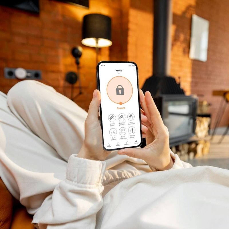 Woman using phone with running smart home security application